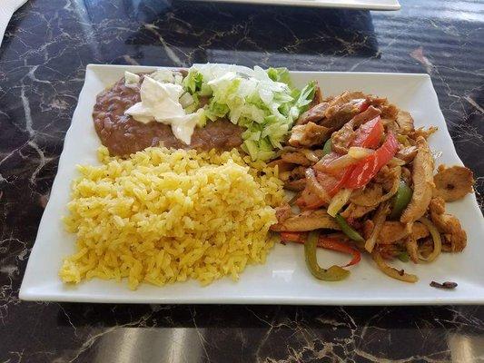 Chicken fajitas with arroz y frijoles.