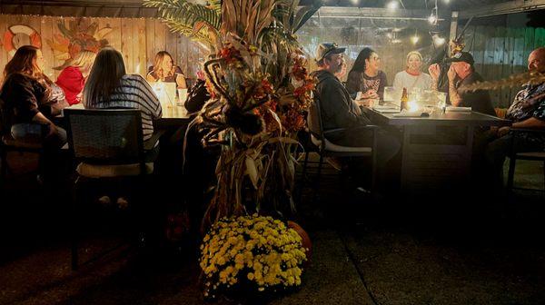 Guest enjoying our full enclosed gazebos  with fire tables for year round outdoor dining