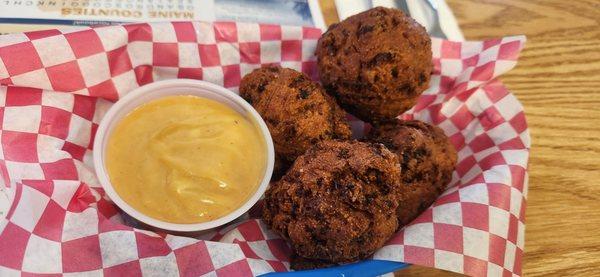 Hushpuppy app from daily specials filled with cheese, ham, sausage, bacon and honey BBQ dip.