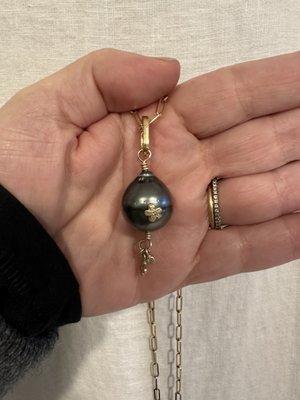 Black Tahitian pearl with gold accents.