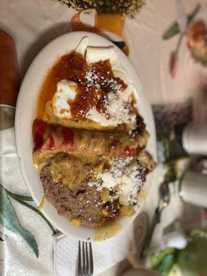 Huevos rancheros with a cheese enchilada, papa and chorizo with a sprinkle of queso fresco.