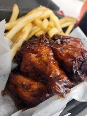 Sauced wings and fries.