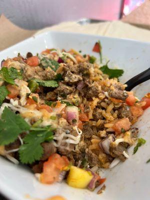 Carne asada, mango salsa, cilantro, onions, rice.