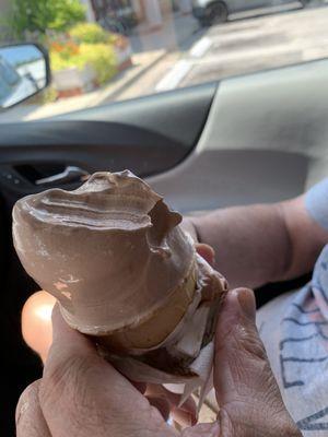 Regular-sized soft serve chocolate ice cream cone.