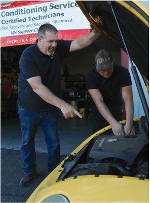 Steve (shop owner) and his head mechanic (and son) working on Steve's Classic Road Runner.