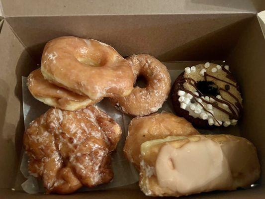 Half dozen donuts and an apple fritter