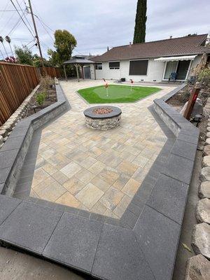 Another big project done new pavers putting green fire pit and walls