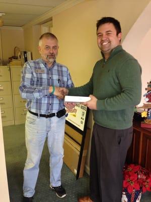 Ben Phillips giving an IPad to lucky winner! This fundraiser helped raise over $2500 for The Widows Harvest. Go TJC Mortgage!