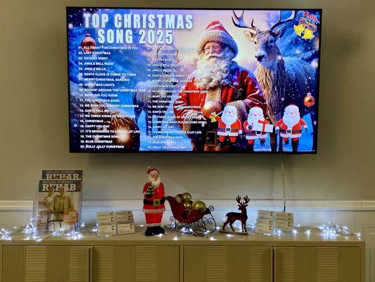 Christmas decor & music playing on the television in the main lobby