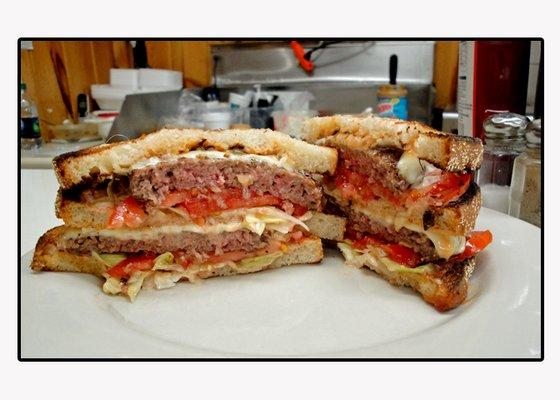 Three slices of English Muffin toast, lettuce, tomato, QBS special sauce, 2 medium rare cheese burgers go into making this Quality McBurger.