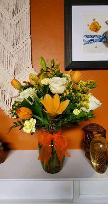 The cheerful arrangement with roses and lilys, beautiful!