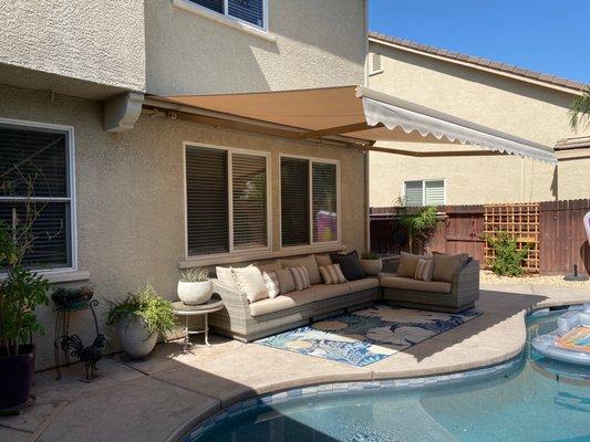 Awning, seating area, and pool