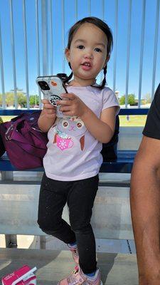 She is texting her friend to make sure she is coming to the game