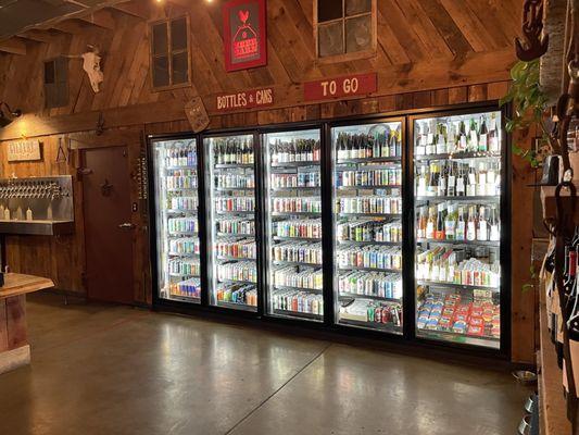 Refrigerator fully stocked with a variety of refreshments.