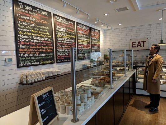 Menu and pastries. Coffee station to the right.