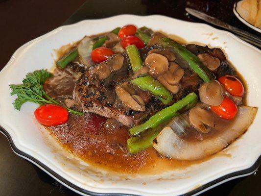 Pepper Steak. Peppercorn NY strip with onion, green pepper, mushroom, tomato. The burgundy wine sauce is incredible.