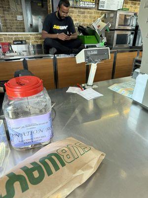 Your employees are sitting on the food prep area with his shoes on!  I will be taking this to the health board.