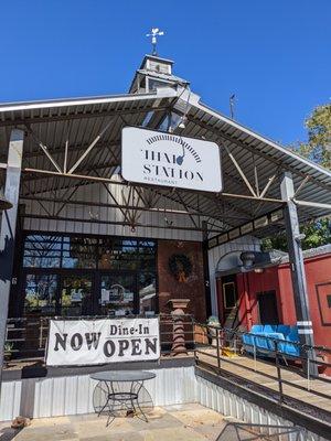 Thai Station restaurant storefront. The restaurant uses old train cars as dining rooms.