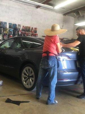 This is the lady who doesn't care about quality control. Here is the evidence of her leaning against my new Tesla with that tool belt.