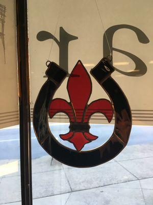 Fleur de lis stained with a University of Louisville theme glass made by a local artist.