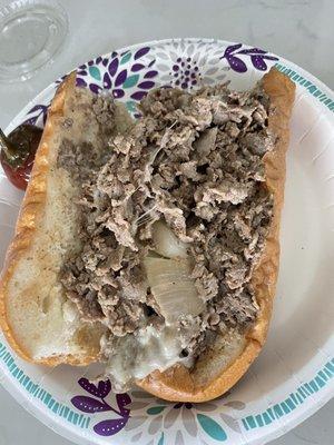 Half of a Philly cheesesteak (with provolone cheese and fried onions)