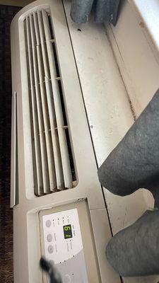 AC falling apart with grime on it.