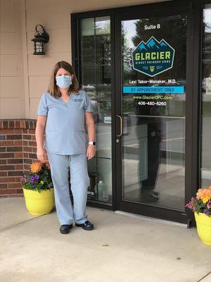 Dr. Tabor-Manaker in front of the Glacier Direct Primary Care entrance at 185 Commons Loop, Suite B, Kalispell.