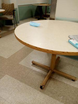 Broken table base in Patient Dining Room, or "Day Room". Unidentified floor. June 2024. Used mask left by unknown person.