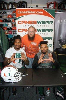 Miami Hurricanes Corn Elder and Rayshawn Jenkins posing with fans during their CanesWear Meet and Greet.