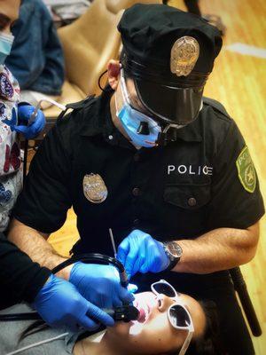 Is that a police playing orthodontist, or an orthodontist playing a police officer?