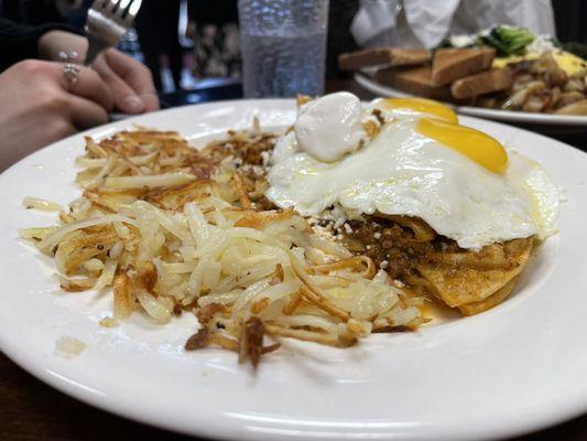 Chilaquiles with sunny side up eggs and hash browns