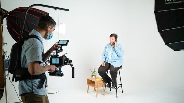 A Bridge City Media videographer shown in a studio setting while filming a commercial.