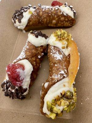 Chocolate and raspberry Cannolis and a candied Orange pistachio Cannoli