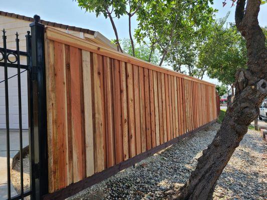 Redwood board on board privacy fence with redwood top cap, redwood trim and pressure treated kicker