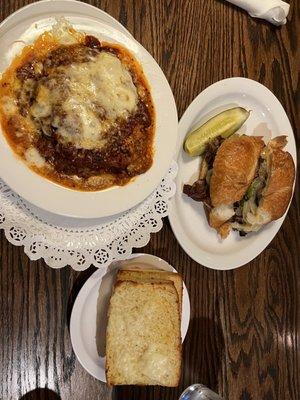 Homemade Lasagna with homemade sauce along with garlic bread and an alpine Swiss sandwich