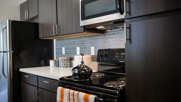 Apartment Kitchen with Stainless Steel Appliances and quartz counters.