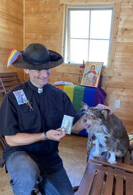 Fr David Peters sharing a St Frances medal with Miss Sophia at the tiny church during Pride event!