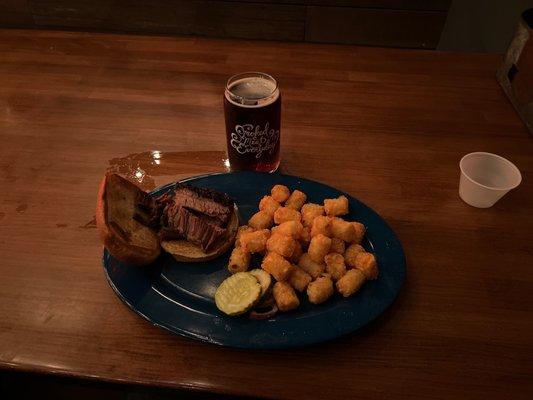 Sliced Brisket Sandwich with Tots and a Cream Ale