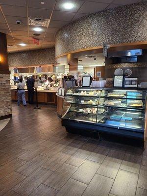 Entrance, pastry case, and Starbucks coffee and line to the food selection.