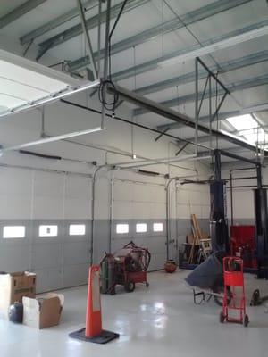 Interior of new 4 bay shop with skylights and bright epoxy floor.