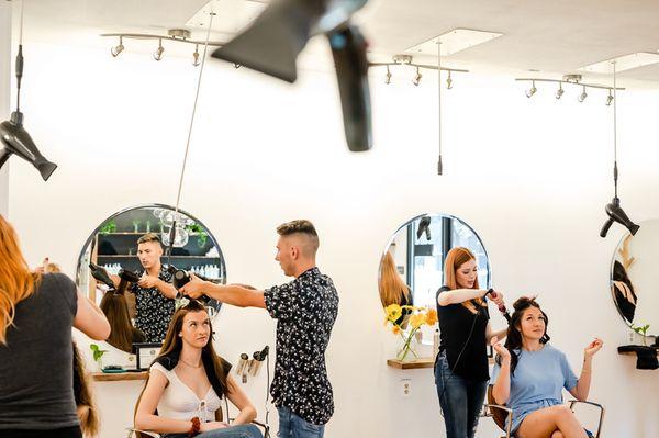 Hair stylists at Blast blow dry in Austin, Texas blowing out hair.