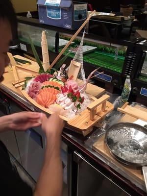 Yi Gao decorating the boat full of fresh Sashimi