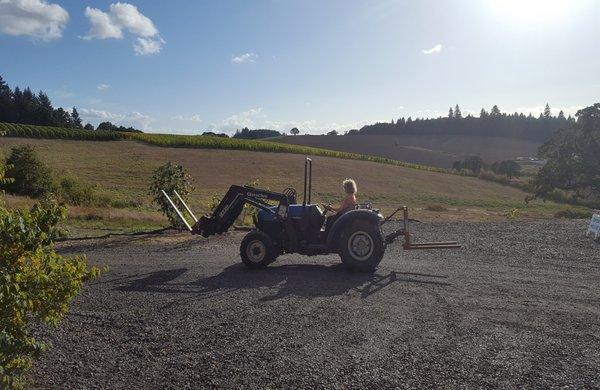 2nd generation farmer Rebecca on the tractor.