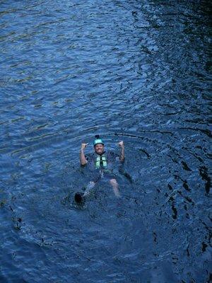 Brian swimming in pool of water at bottom of waterfall. Shaka!