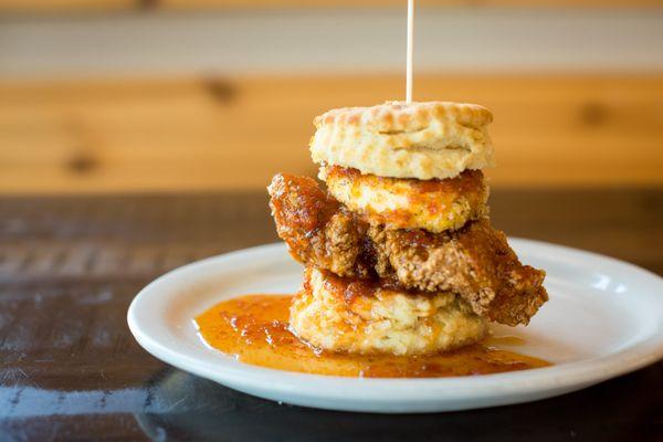 The Squawking Goat: Fried chicken, breaded and toasted goat cheese, topped with house made sweet pepper jelly, all on a biscuit sandwich.