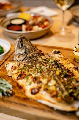 Whole Branzino herb stuffed with spinach, calabrian chilis and lemon.