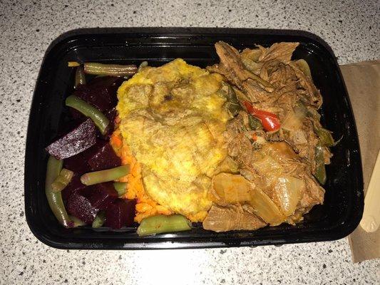 Shredded beef, yellow rice, tostones and vegetable