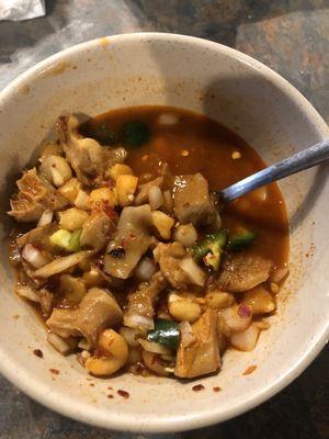 Menudo with onion, crushed red pepper and jalapeños