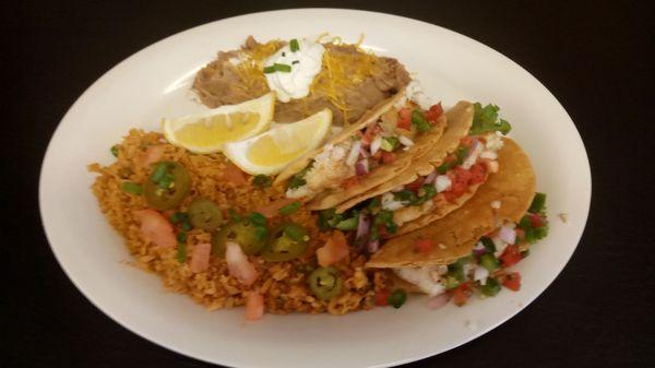 Fish taco,serve with lettuce, Pico de Gallo shredded cheese and salsa. Sides Mexican rice and refried beans.