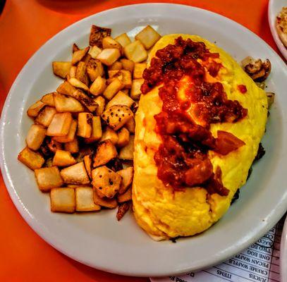 Steak and cheese omelet with mushrooms onion Bell Peppers and Swiss cheese. With hash browns.